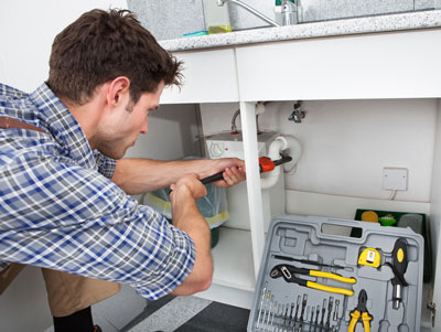 Plumber fixing drain